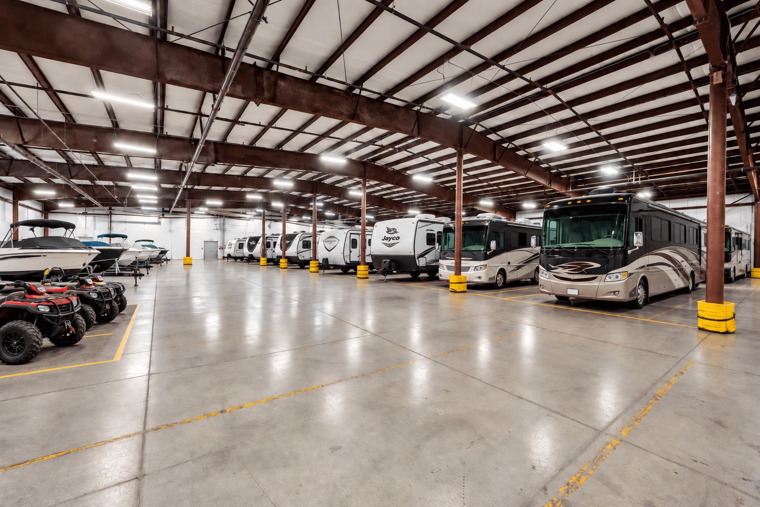 Rows of RVs, boats, and UTVs parked inside the heated Jenson Storage building in Logan, Utah