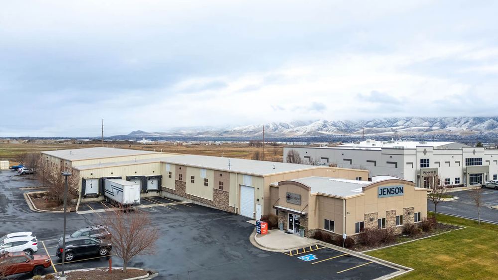 Aerial view of the Jenson Storage building with the Cache Valley mountains in the background